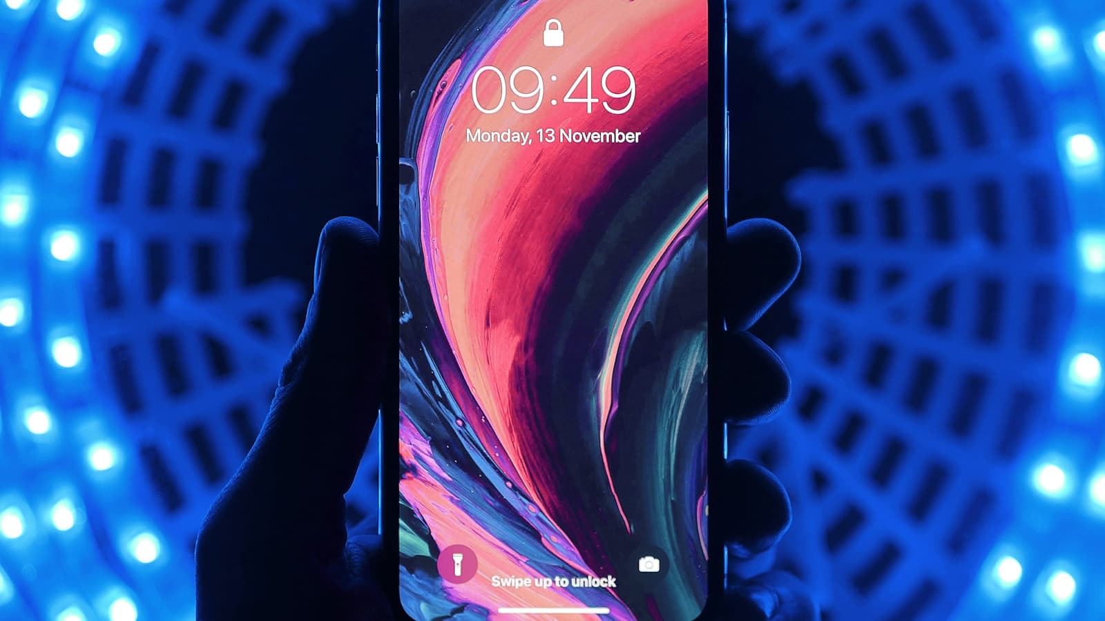 A phone lock screen held in a hand