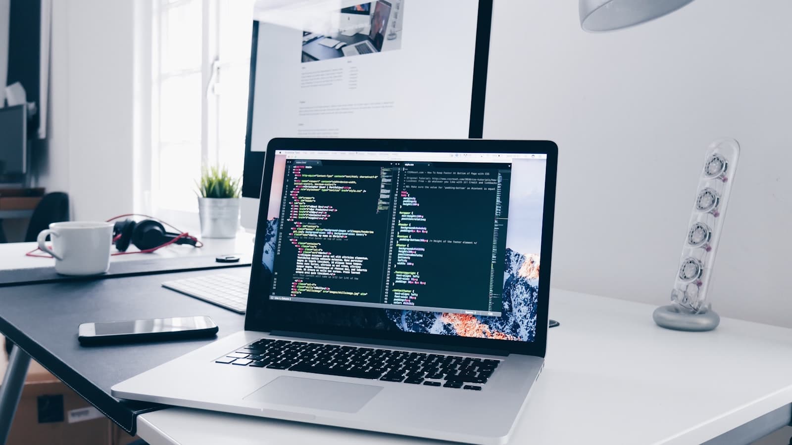 A monitor showing code in a dark editor