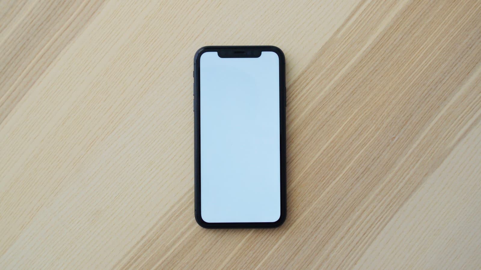 A smartphone lying on a wooden table